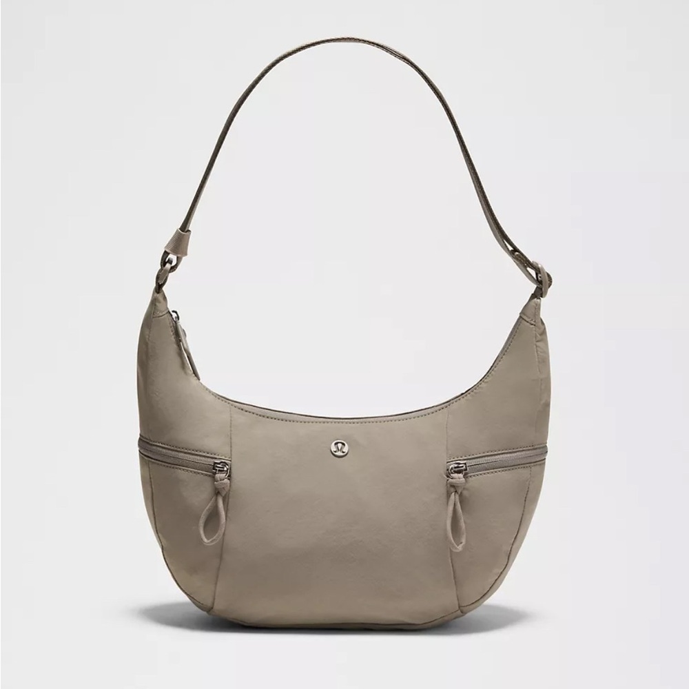 **BRAND NEW, NEVER USED**
Lululemon Athletica Warm Ash Grey Slouchy Sling Bag 6L